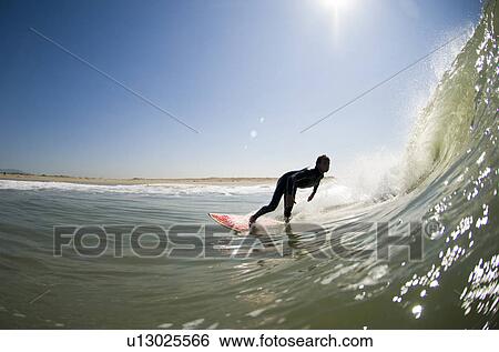 Stock Photograph - A male surfer. Fotosearch