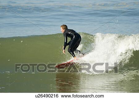 Stock Photograph - A male surfer. Fotosearch