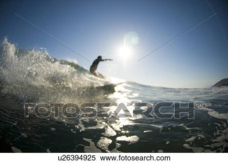 Stock Photography - A male surfer. Fotosearch