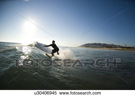 Stock Photography - A male surfer. Fotosearch