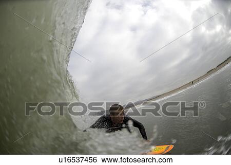 A male surfing View Large Photo Image Stock Photograph - A male surfing. Fotosearch