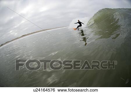 Stock Photograph - A male surfing. Fotosearch