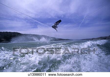 A male wake boarding doing an air View Large Photo Image Stock Image - A male wake boarding doing an air. Fotosearch