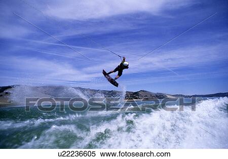 A male wake boarding doing an air View Large Photo Image Stock Photography - A male wake boarding doing an air. Fotosearch