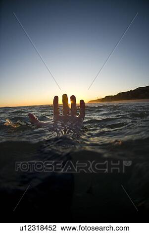 Stock Image - A male's hand in the water. Fotosearch