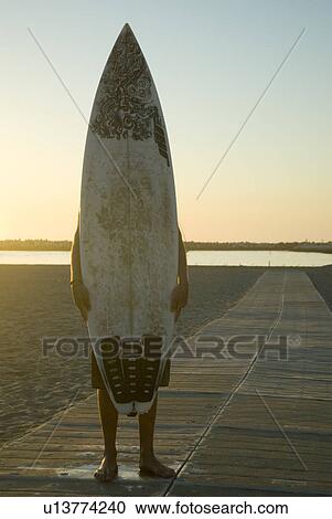 A Surfer behind his board View Large Photo Image Stock Image - A Surfer behind his board. Fotosearch