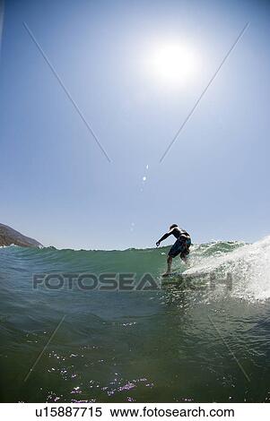 Stock Photography - A surfer hanging five at Leo Carrillo State Beach California USA. Fotosearch