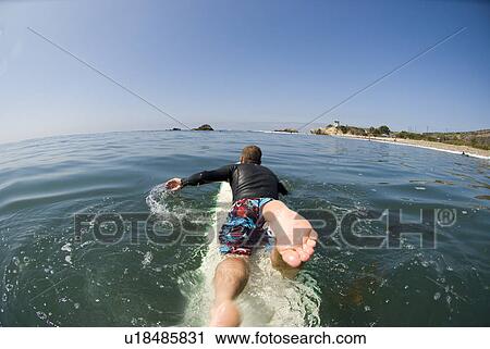 A surfer paddling out at Leo Carrillo State Beach California, USA View Large Photo Image Stock Image - A surfer paddling out at Leo Carrillo State Beach California, USA. Fotosearch