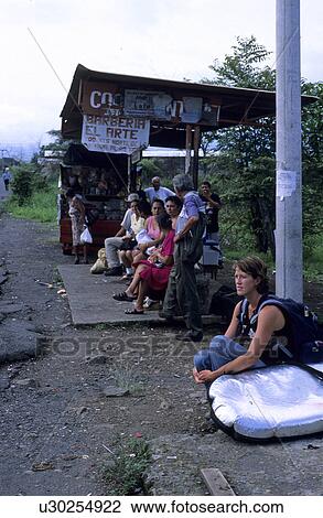 A young Caucasian women with a surfboard waiting for a bus at a Costa Rican bus stop View Large Photo Image Stock Image - A young Caucasian women with a surfboard waiting for a bus at a Costa Rican bus stop. Fotosearch