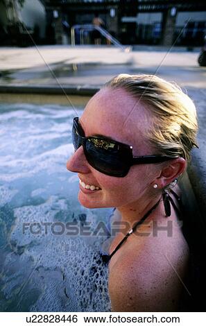 Stock Photograph - A young female enjoying a relaxing day in the jucuszi. Fotosearch