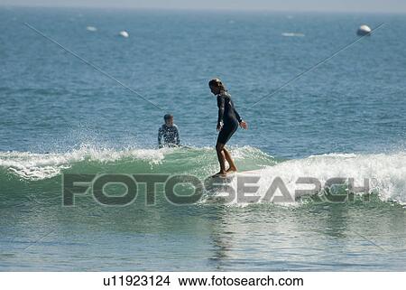 Picture - A young girl surfing. Fotosearch