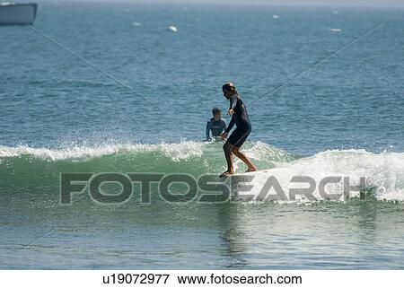 A young girl surfing View Large Photo Image Stock Photo - A young girl surfing. Fotosearch