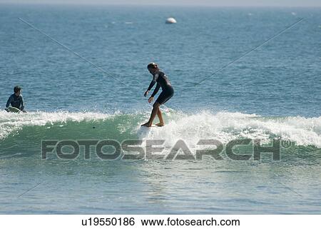 A young girl surfing View Large Photo Image Stock Photograph - A young girl surfing. Fotosearch
