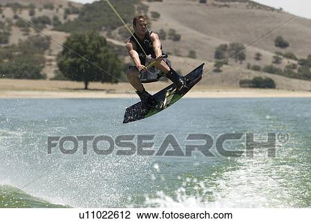 A young male wake boarding View Large Photo Image Stock Image - A young male wake boarding. Fotosearch