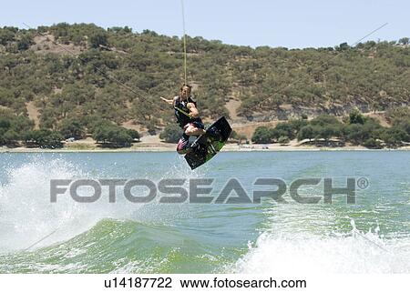 Stock Image - A young male wake boarding. Fotosearch