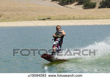 A young male wake boarding View Large Photo Image Stock Image - A young male wake boarding. Fotosearch