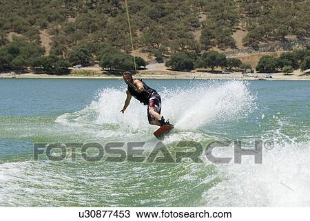 A young male wake boarding View Large Photo Image Stock Image - A young male wake boarding. Fotosearch