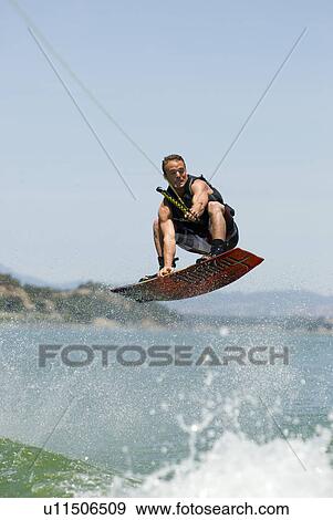 A young male wake boarding View Large Photo Image Stock Photo - A young male wake boarding. Fotosearch