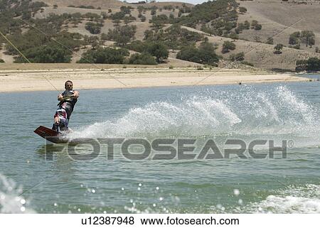 A young male wake boarding View Large Photo Image Stock Photo - A young male wake boarding. Fotosearch