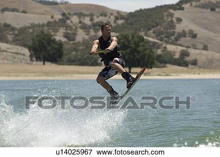 A young male wake boarding View Large Photo Image Stock Photo - A young male wake boarding. Fotosearch