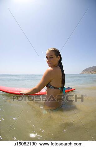 A young surfer girl out in the ocean View Large Photo Image Stock Image - A young surfer girl out in the ocean. Fotosearch