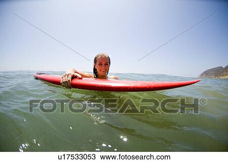 A young surfer girl out in the ocean View Large Photo Image Stock Image - A young surfer girl out in the ocean. Fotosearch