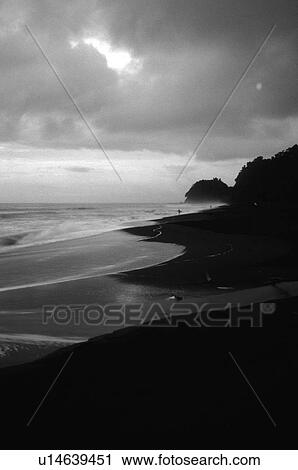 Stock Image - Black and white photo of a beach. Fotosearch