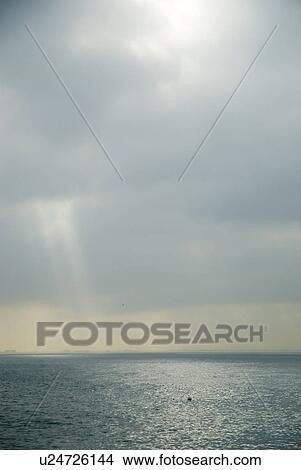 Cloudy sky over water View Large Photo Image Picture - Cloudy sky over water. Fotosearch