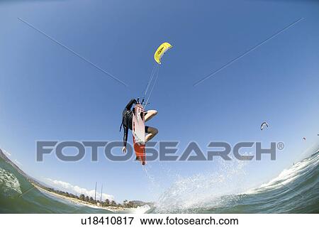 Stock Photo - Extreme kite surfer in the air. Fotosearch