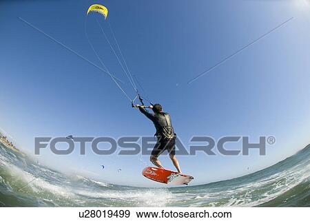 Stock Photo - Extreme kite surfer in the air. Fotosearch