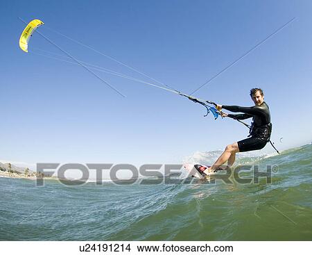 Extreme kite surfer in the water View Large Photo Image Picture - Extreme kite surfer in the water. Fotosearch