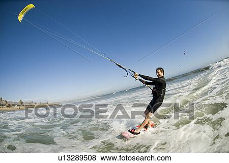 Extreme kite surfer in the water View Large Photo Image Stock Photo - Extreme kite surfer in the water. Fotosearch