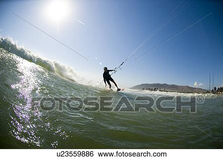 Extreme kite surfer in the water View Large Photo Image Stock Photograph - Extreme kite surfer in the water. Fotosearch
