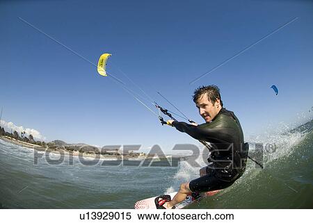 Stock Photography - Extreme kite surfer in the water. Fotosearch