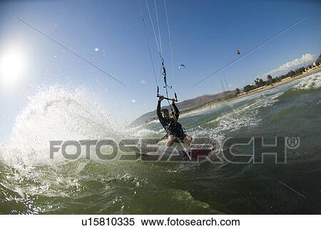 Extreme kite surfer in the water View Large Photo Image Stock Photography - Extreme kite surfer in the water. Fotosearch