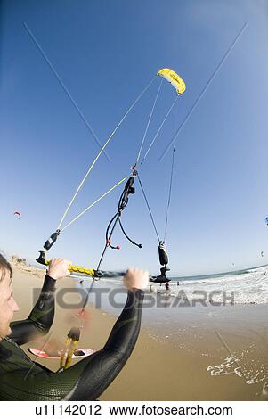 Extreme kite surfer on the beach View Large Photo Image Stock Image - Extreme kite surfer on the beach. Fotosearch