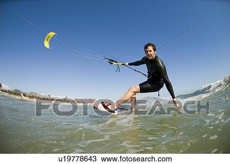 Stock Image - Extreme kite surfer. Fotosearch