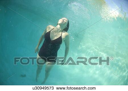 Female swimming under water View Large Photo Image Stock Image - Female swimming under water. Fotosearch
