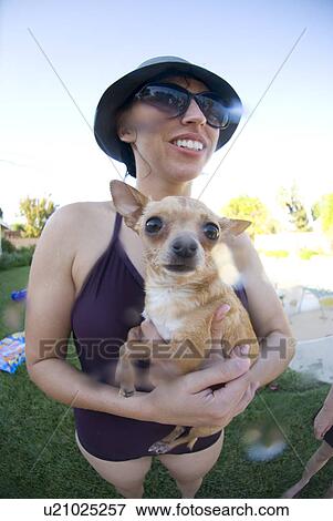 Female with her Chihuahua dog by the pool View Large Photo Image Stock Photo - Female with her Chihuahua dog by the pool. Fotosearch