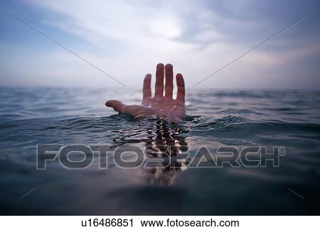 Stock Image - Hand coming out of the ocean. Fotosearch