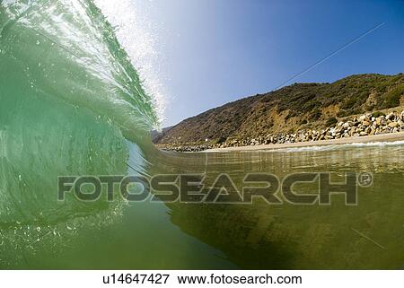 Stock Photo - Inside of a wave breaking. Fotosearch