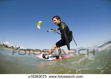 Stock Photography - Kite surfer in action. Fotosearch
