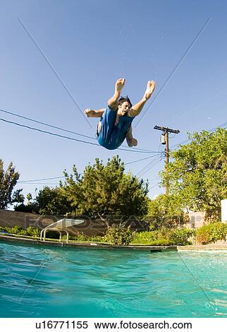 Stock Photography - Male diving into a home pool. Fotosearch