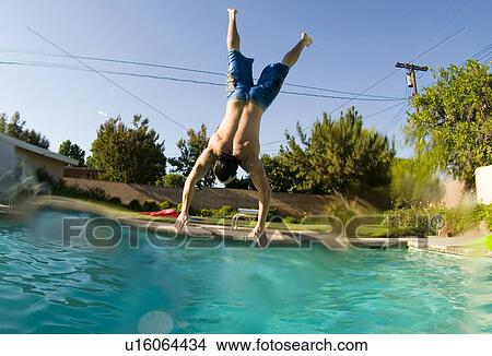 Male diving into a outdoor home pool View Large Photo Image Picture - Male diving into a outdoor home pool. Fotosearch