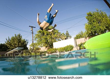 Male diving into an outdoor home pool View Large Photo Image Stock Image - Male diving into an outdoor home pool. Fotosearch