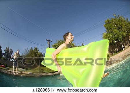 Male diving into an outdoor home pool View Large Photo Image Stock Photo - Male diving into an outdoor home pool. Fotosearch