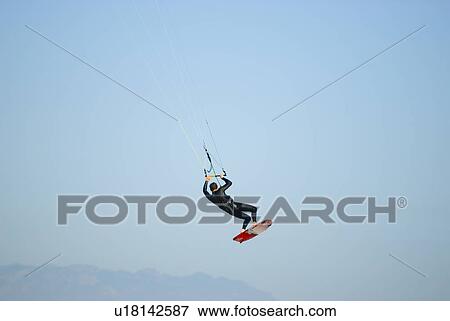 Male kite surfing in the air View Large Photo Image Stock Photo - Male kite surfing in the air. Fotosearch