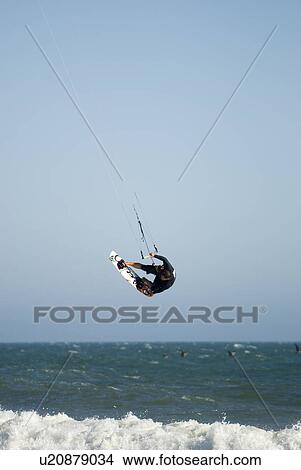 Picture - Male kite surfing. Fotosearch