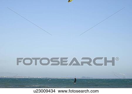 Picture - Male kite surfing. Fotosearch