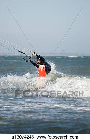 Stock Photograph - Male kite surfing. Fotosearch